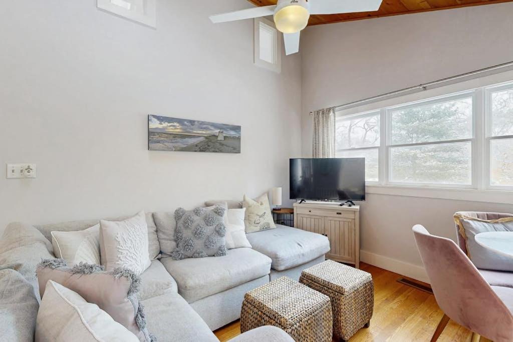 a living room with a couch and a flat screen tv at Fresh Pond Chateau in Oak Bluffs