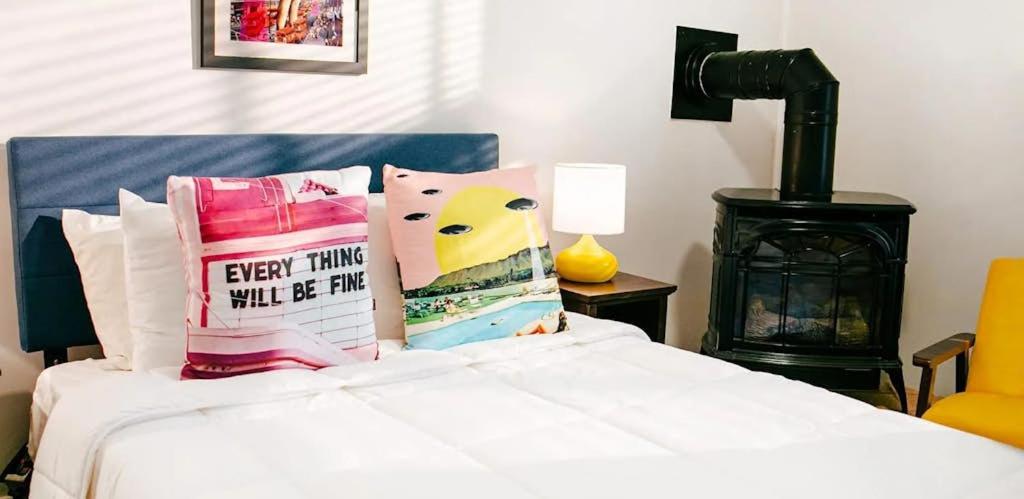 a bedroom with a bed with pillows and a stove at Paul Revere in Provincetown