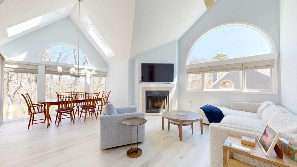 a living room with a couch and a table at Fairway Bliss at Ocean Edge in Brewster