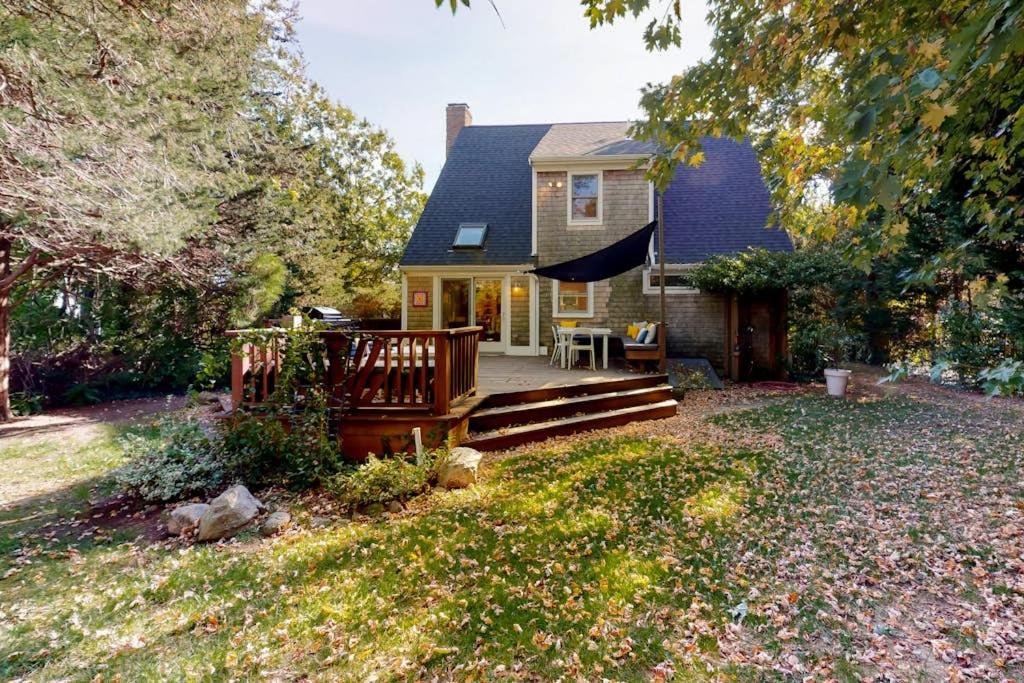a small house with a porch and a deck at Osprey View Villa in Dennis