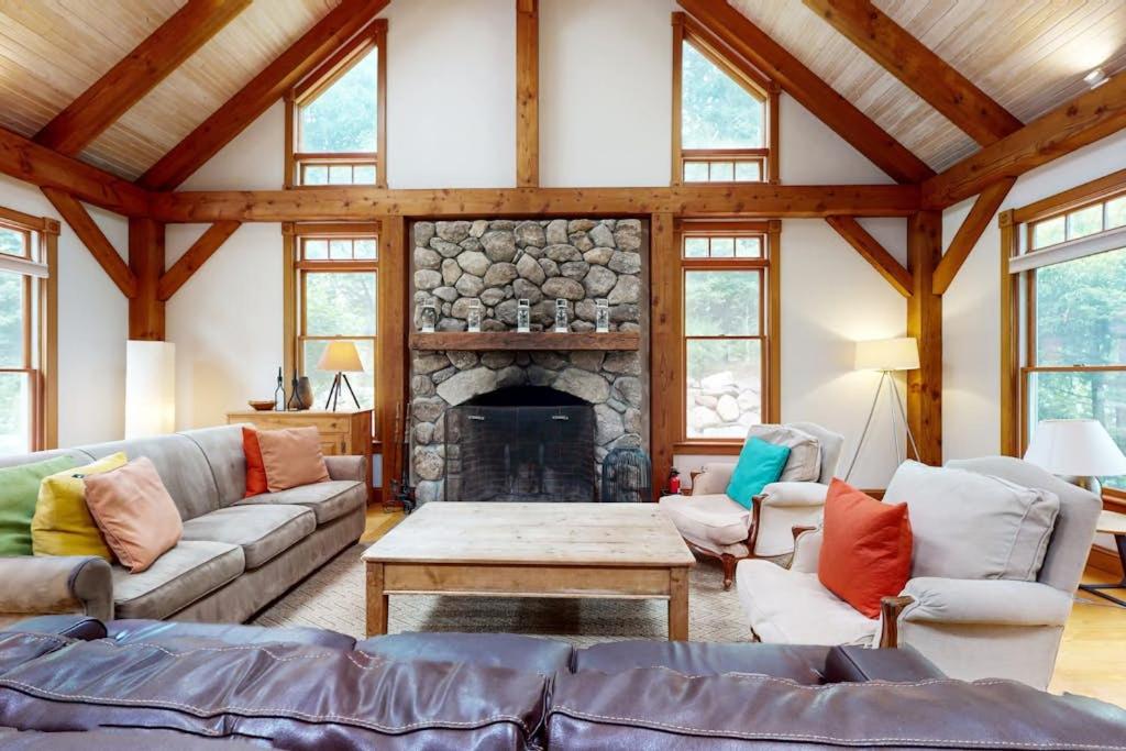 a living room with a couch and a fireplace at Bumps River Bungalow in Centerville