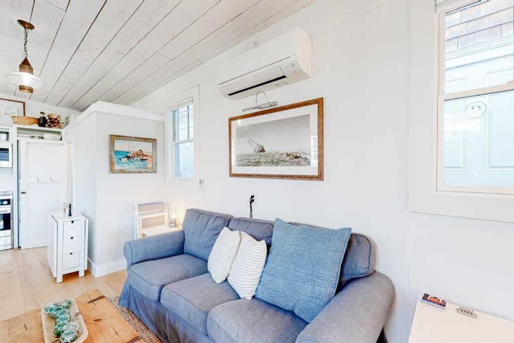 a living room with a blue couch in a room at Long Point Getaway in Provincetown
