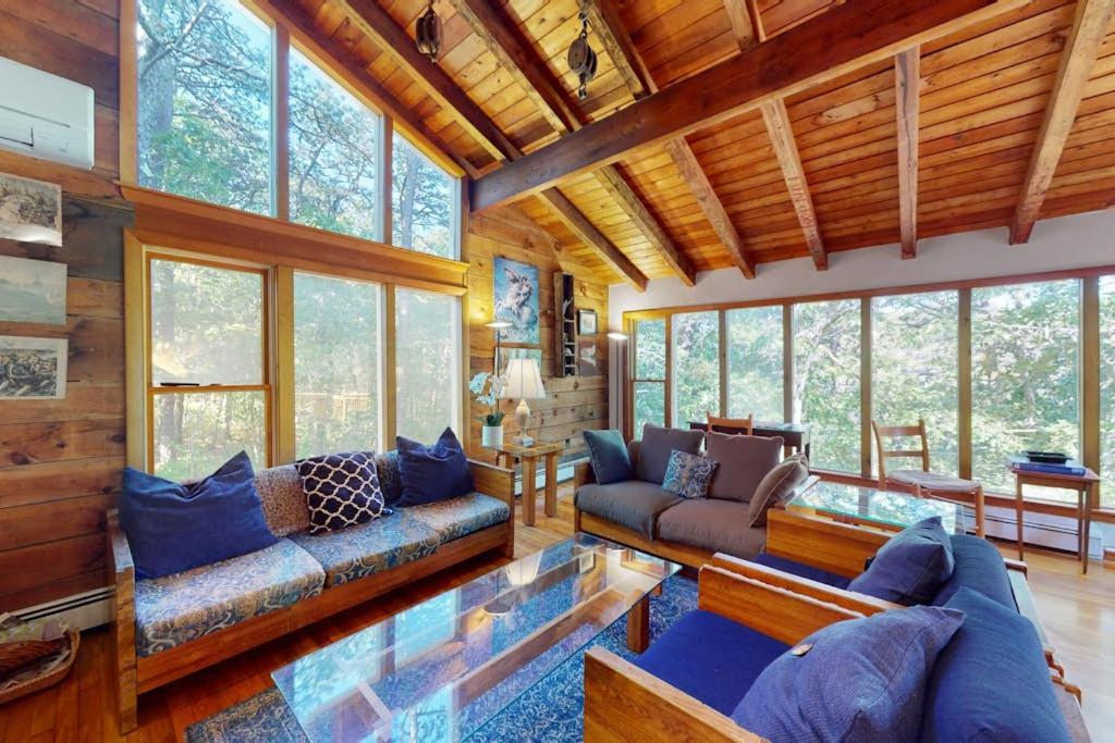 a living room with a lot of windows at Old Kings Hideout in Wellfleet