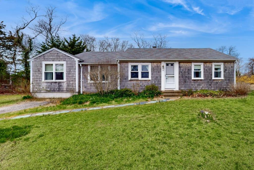 a house with a green lawn in front of it at Namskaket Retreat in Orleans