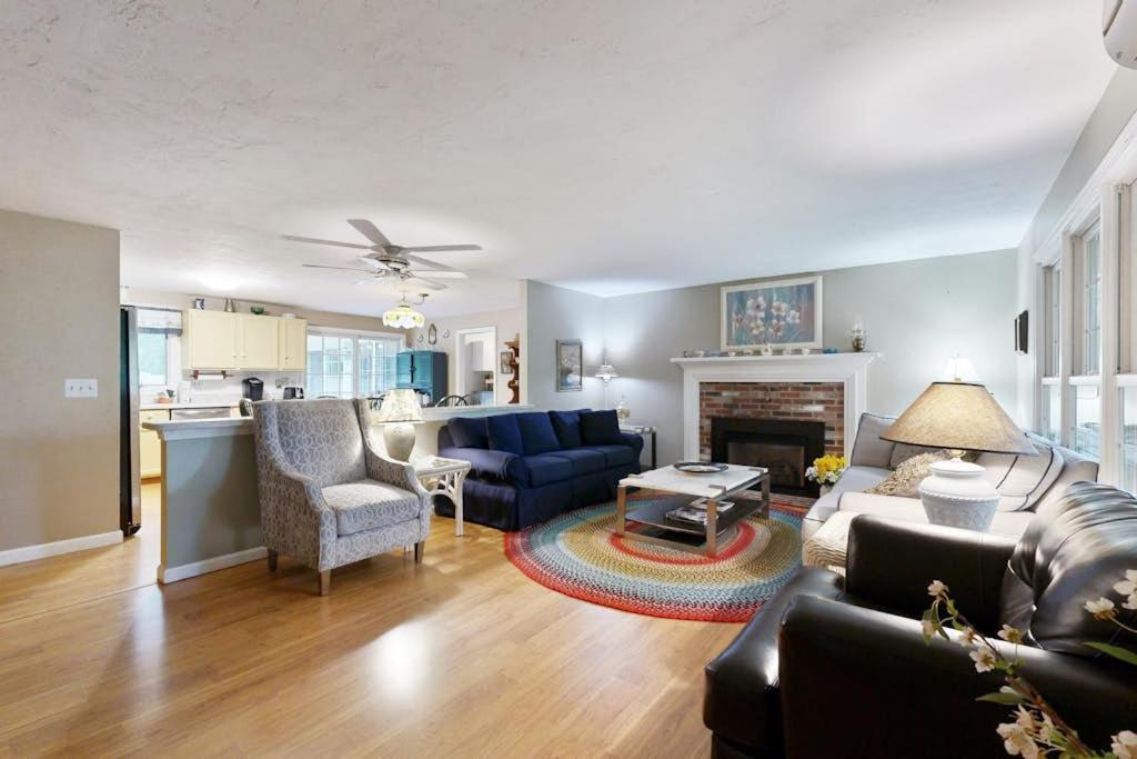 a living room with a couch and a fireplace at Lobster Rock Retreat in Barnstable