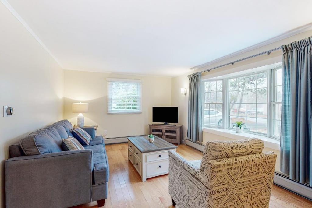 a living room with a couch and a tv at Jesmond Cottage in Harwich