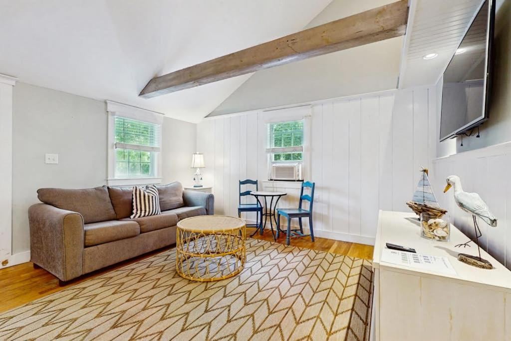 a living room with a couch and a table at Salty Kisses Unit 20 in Yarmouth