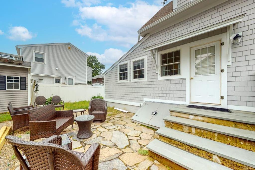 a patio with rocking chairs and a house at Onset Grove in Onset