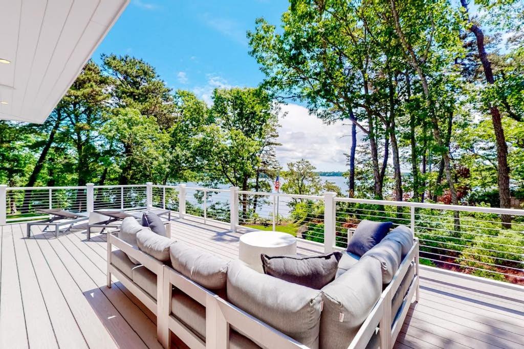 a patio with couches and tables on a deck at Follins Estate in Yarmouth Port