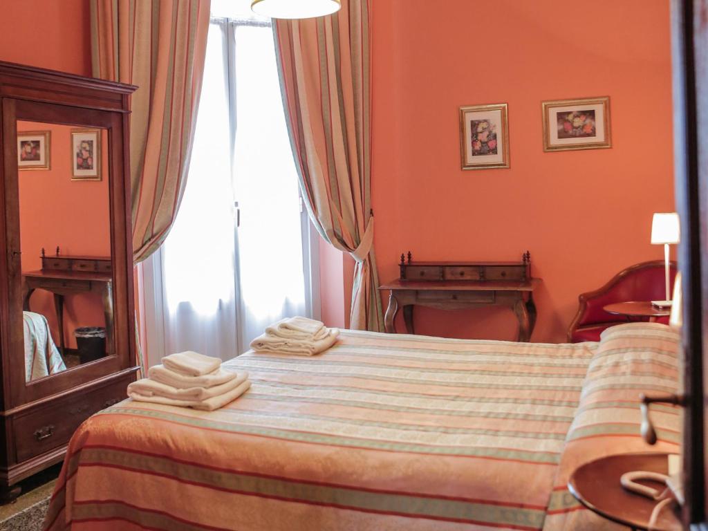 Postel nebo postele na pokoji v ubytování Hotel Delle Rose