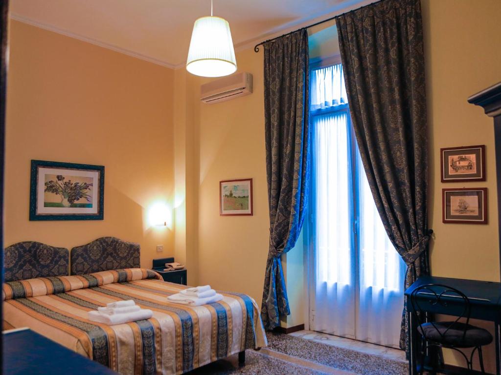 Postel nebo postele na pokoji v ubytování Hotel Delle Rose