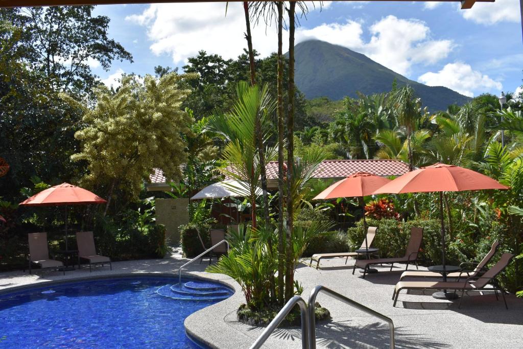フォルトゥナにあるHotel Roca Negra Del Arenalの山の景色を望むプール(椅子、パラソル付)