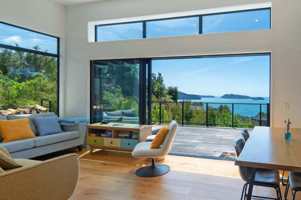 a living room with a view of the ocean at Kokomea in Kaiteriteri
