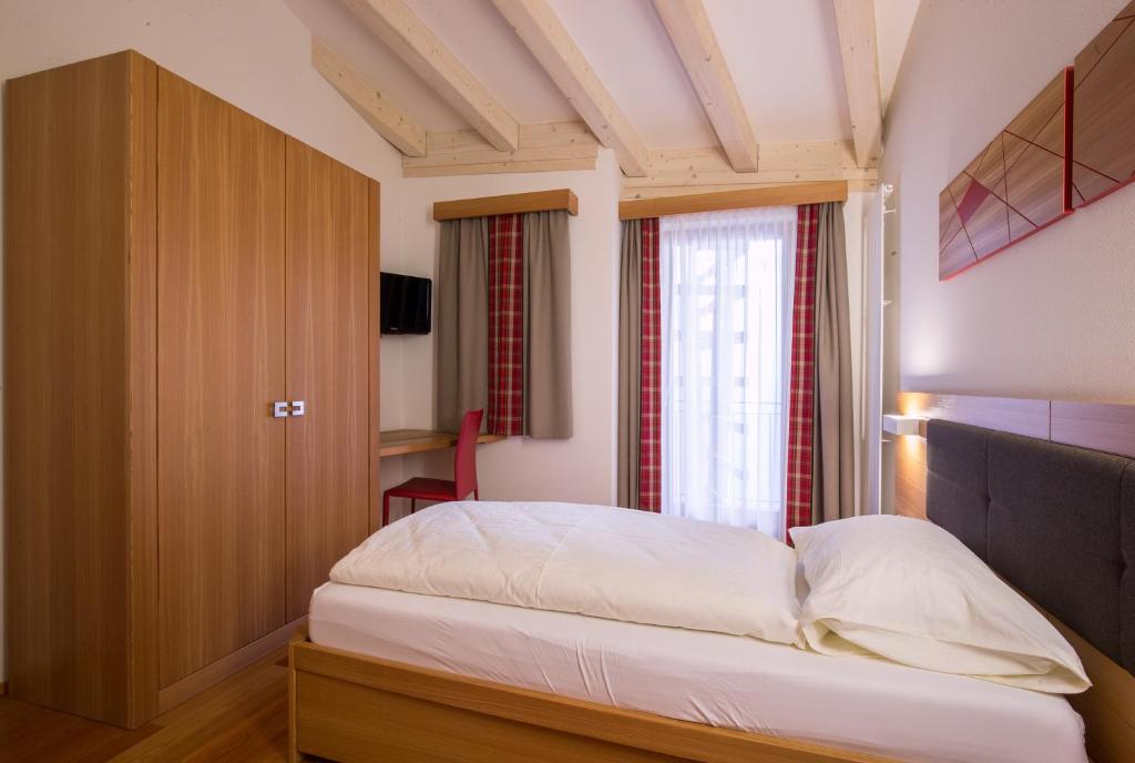 Postel nebo postele na pokoji v ubytování Hotel Al Cervo