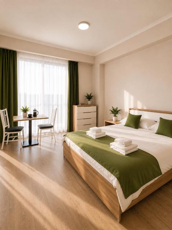 a large bedroom with a large bed and a desk at N4 Alvina Complex in Tsaghkadzor