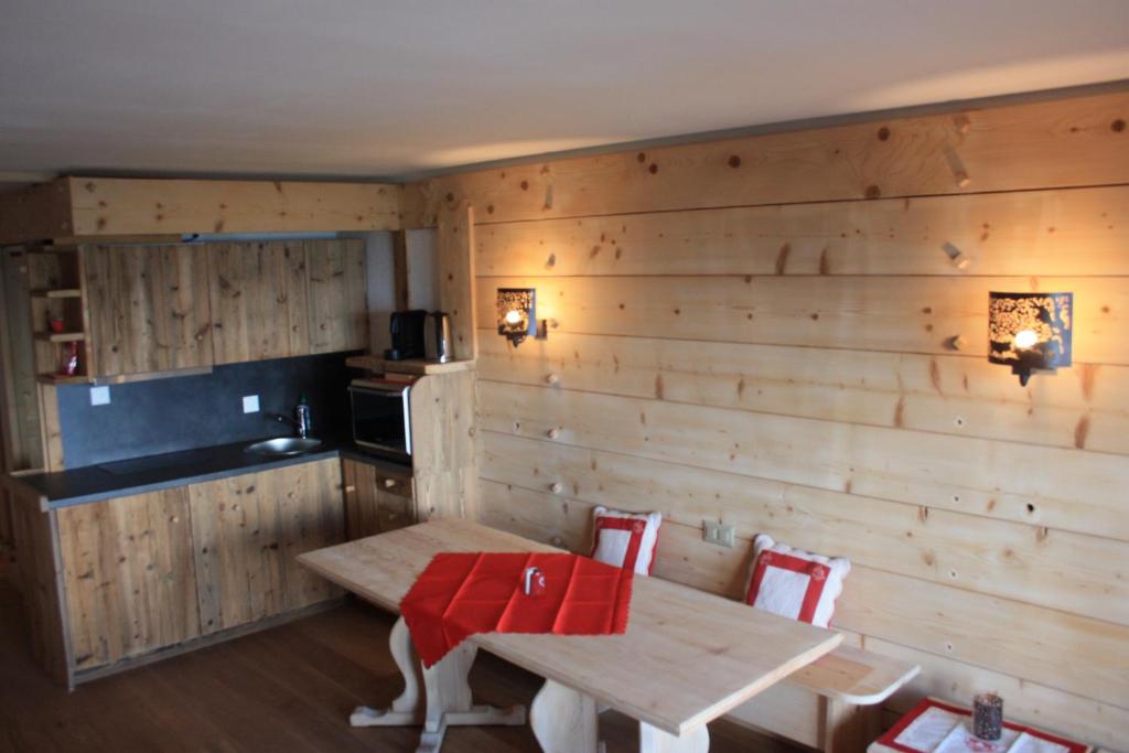 a room with a wooden wall with a table and chairs at Le Bristol - Villars Bristol Apartments in Villars-sur-Ollon