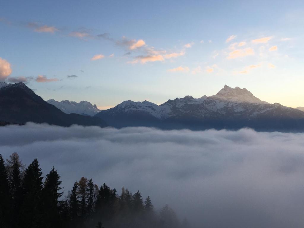 a view of a foggy valley with mountains in the background at Le Bristol - Villars Bristol Apartments in Villars-sur-Ollon