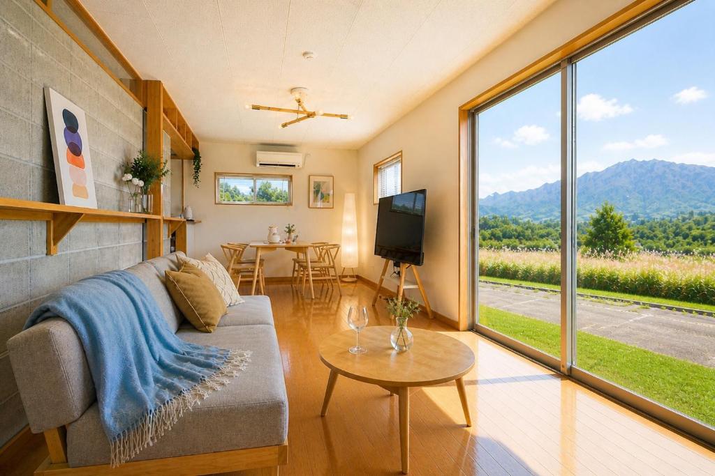 a living room with a couch and a large window at Building D - Vacation STAY 84939v in Bōchū