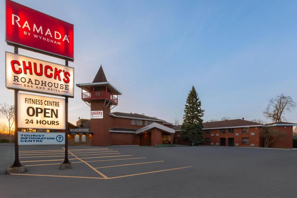 a sign in a parking lot in front of a building at Ramada by Wyndham Arnprior in Arnprior