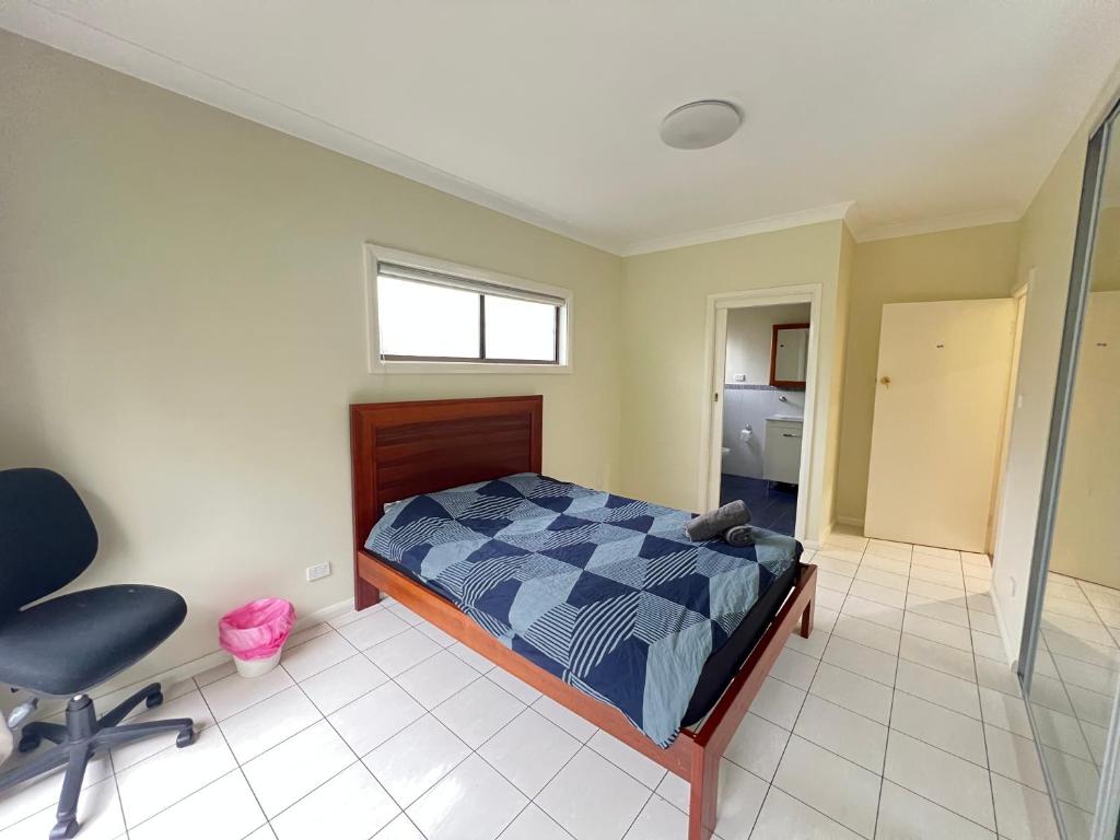 a bedroom with a bed and a desk and a chair at Room 31 in Sydney