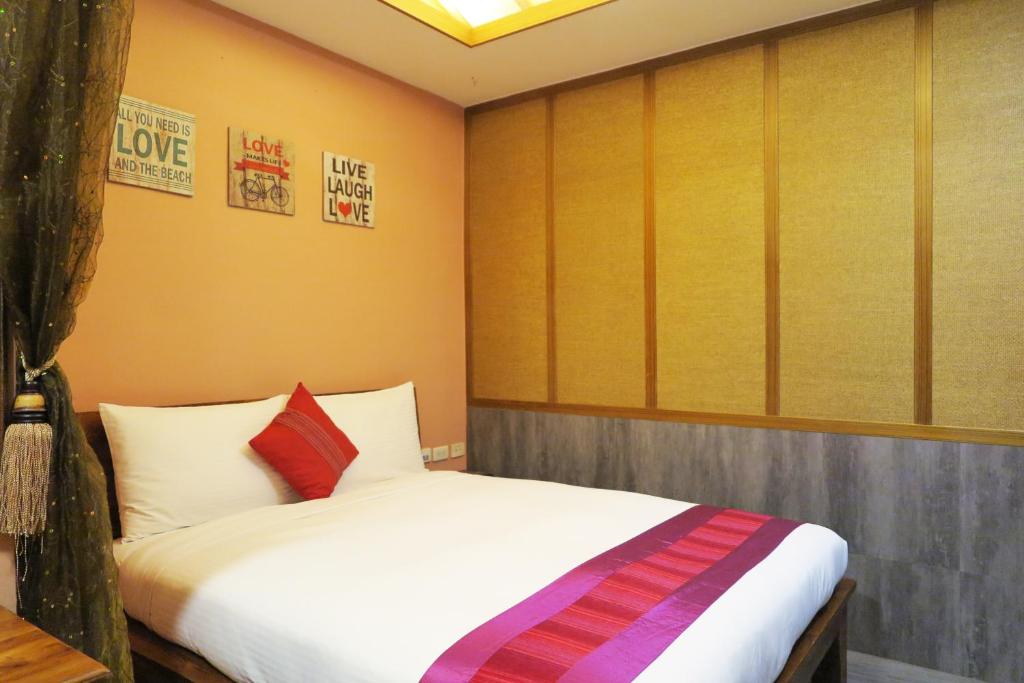 Postel nebo postele na pokoji v ubytování Kenting Sin Sin Hotel