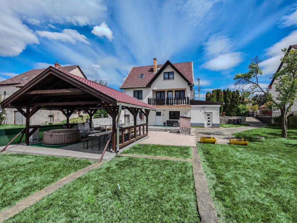 a house with a pavilion in the yard at Artemis Vendégház in Bogács