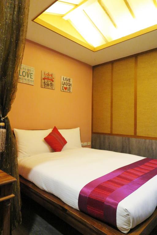 Postel nebo postele na pokoji v ubytování Kenting Sin Sin Hotel