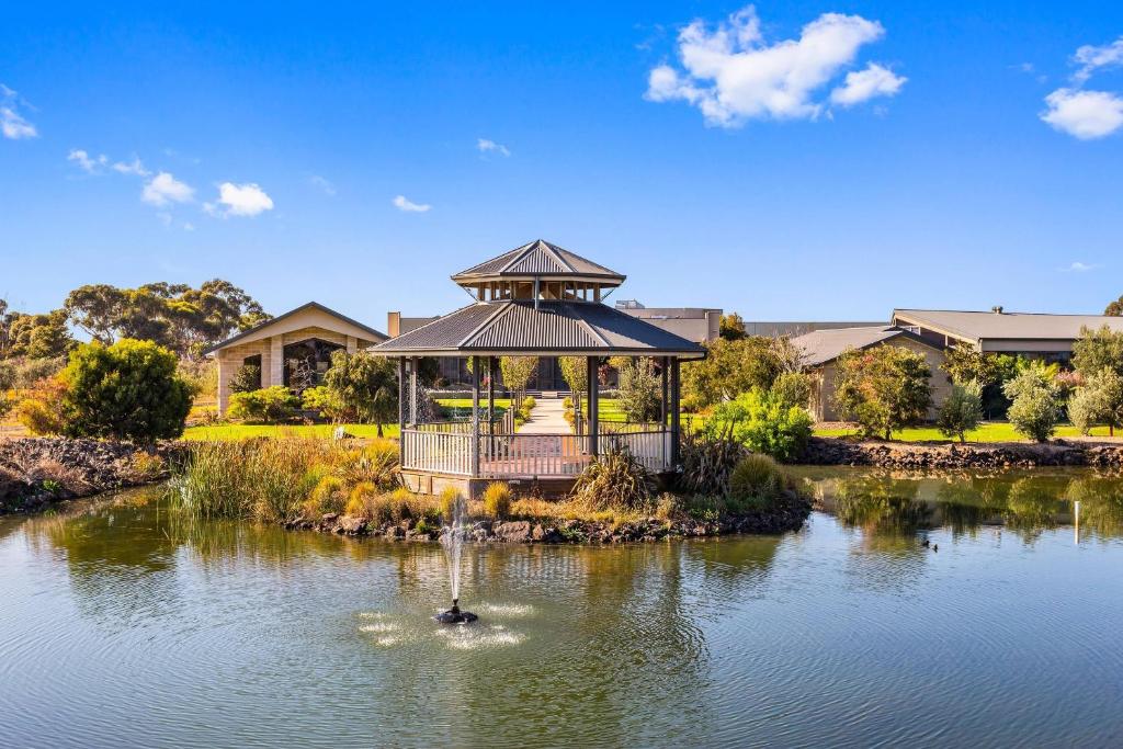 a gazebo in the middle of a pond with a fountain at Quality Hotel Point Cook in Point Cook