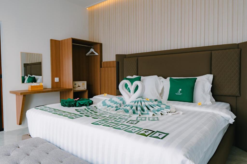 a hotel room with a bed with a swan on it at Kawaland glamping resort in Telukbakau