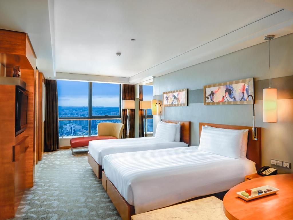 Postel nebo postele na pokoji v ubytování Swissotel Foshan, Guangdong - Free shuttle to Canton Fair
