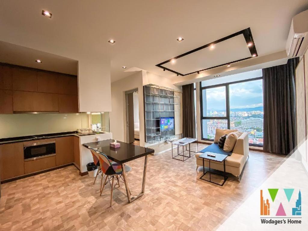 a kitchen and living room with a couch and a table at KLCC Expressionz by WGS, 300Mbps WiFi in Kuala Lumpur