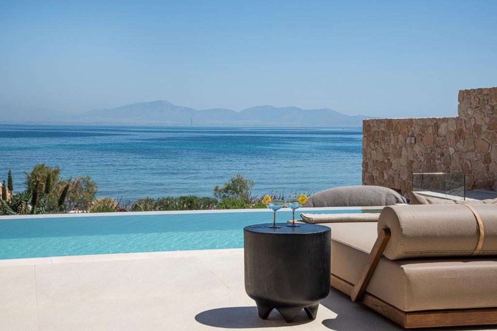 a living room with a couch and a view of the ocean at AÁSHNA Suites and Residences in Vaia