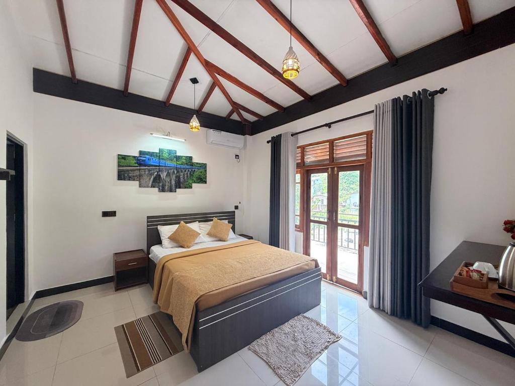 a bedroom with a large bed and a window at Maya 44 Boutique Ella in Ella