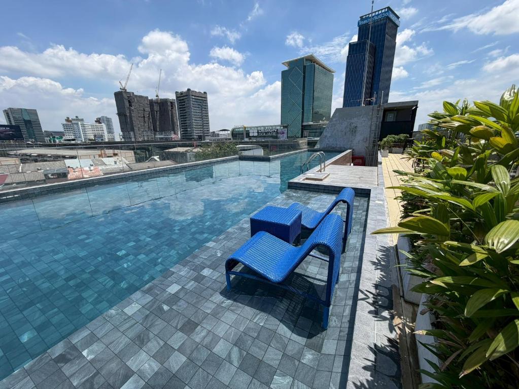 a swimming pool on top of a building at De Botan Bangna in Bangkok