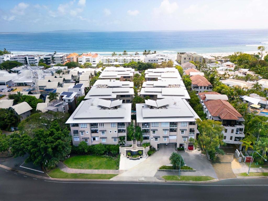 an aerial view of a city with houses and the ocean at The Sebel Noosa in Noosa Heads
