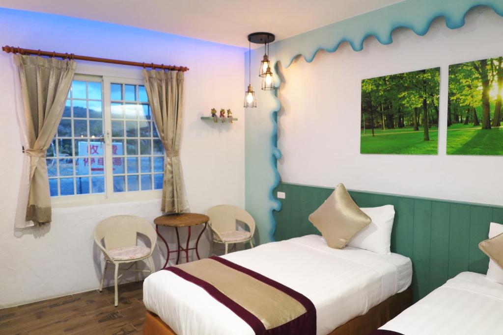 Postel nebo postele na pokoji v ubytování Kenting Sin Sin Hotel IIl