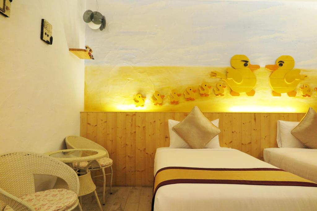 Postel nebo postele na pokoji v ubytování Kenting Sin Sin Hotel IIl