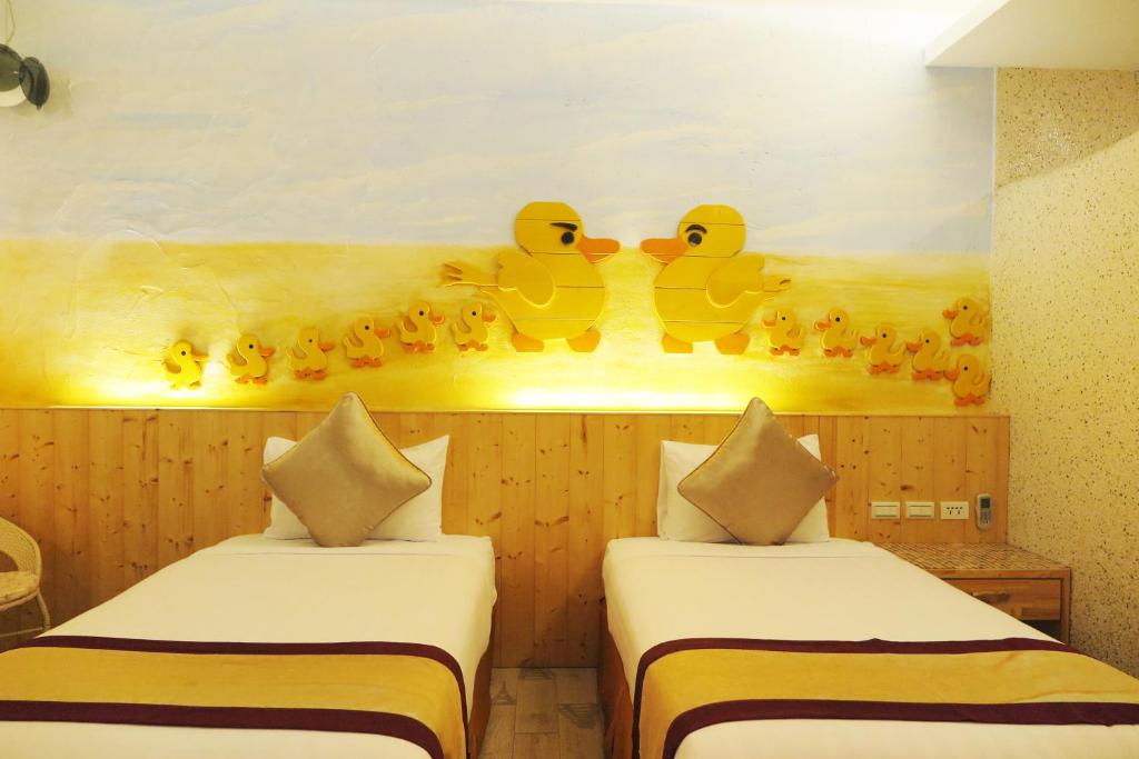 Postel nebo postele na pokoji v ubytování Kenting Sin Sin Hotel IIl