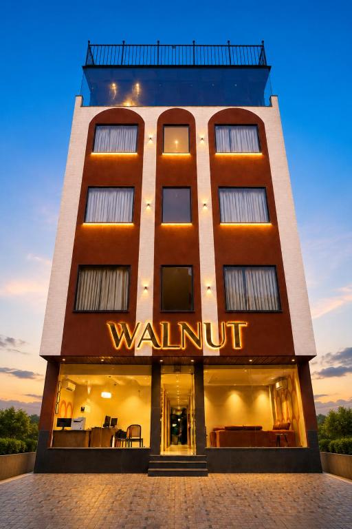 a building with a sign that reads walnut at Hotel Walnut - Near Jaipur Airport in Jaipur