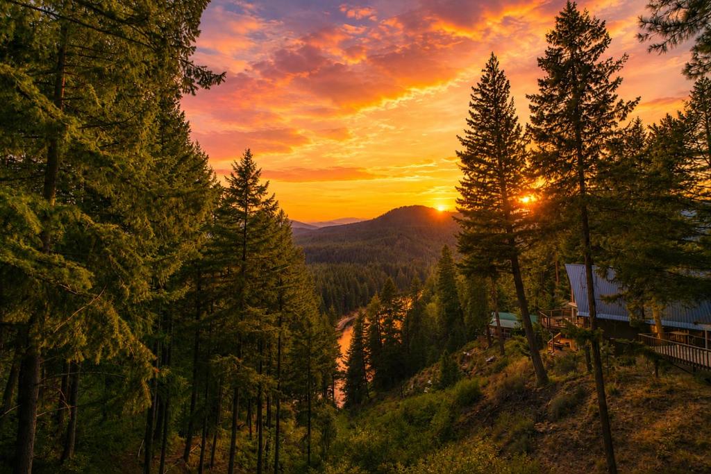 a sunset in the mountains with trees and a river at Das Tree Haus by NW Comfy Cabins in Leavenworth