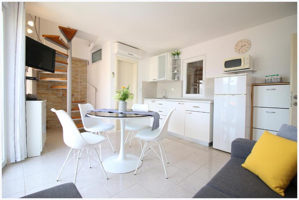 a kitchen and living room with a table and chairs at Apartment Karmela in Primošten