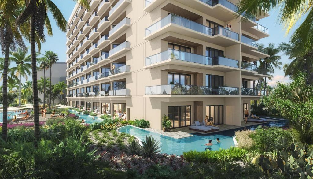 an apartment building with a swimming pool and a resort at Hilton Aruba Caribbean Resort & Casino in Palm-Eagle Beach