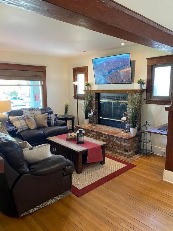 a living room with a couch and a fireplace at "Univeristy" Charming Craftsman - 3 bd, 2ba in Riverside in Riverside