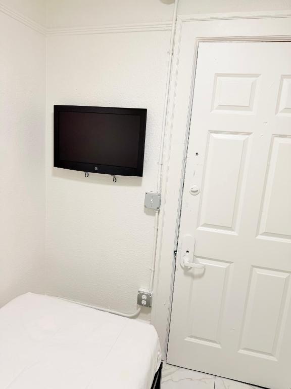a room with a door and a tv on the wall at Adrian Hotel in San Francisco