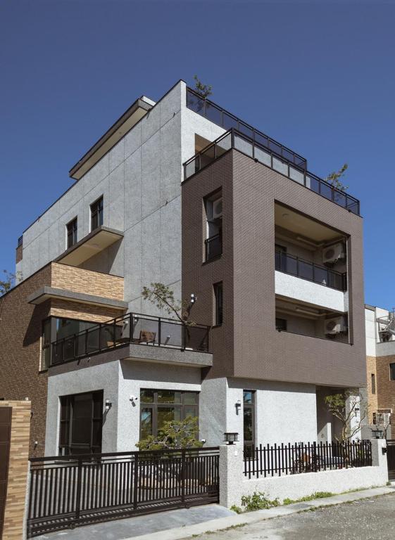 a building with balconies on the side of it at Chungi Hotel 純吉民宿 咖啡 in Xincheng