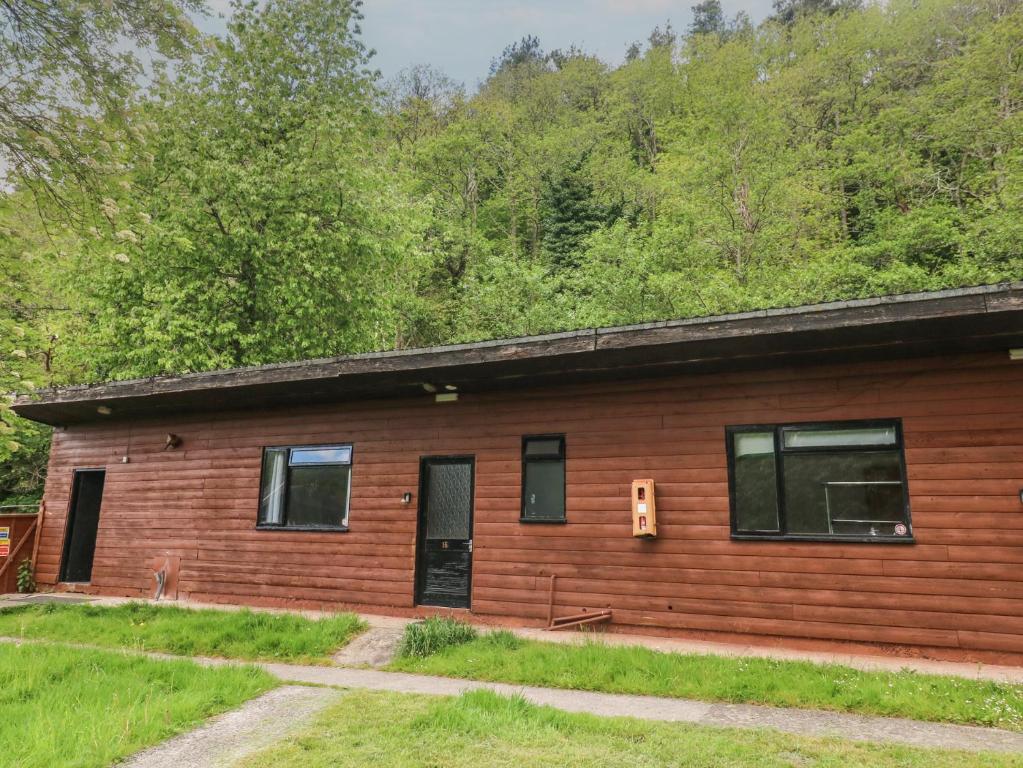 a log cabin with a door and windows at Cabin No 16 - Salt and Fern Cabins in Port Talbot