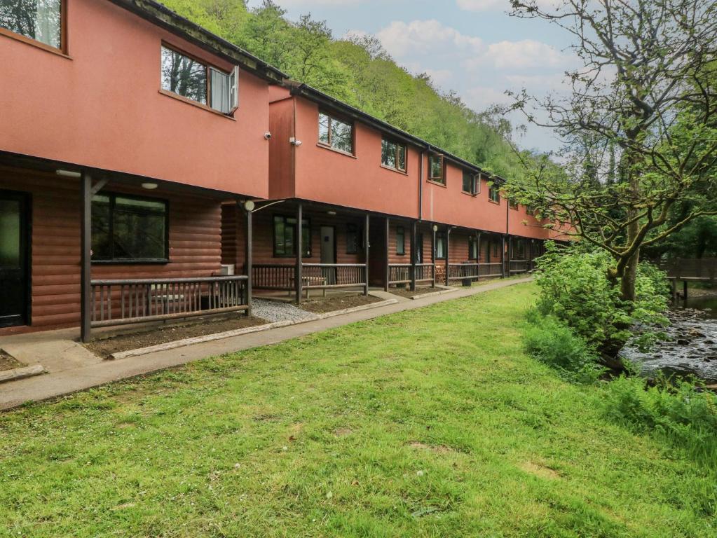 a row of buildings with grass in the foreground at Cabin No 11 - Salt and Fern Cabins in Port Talbot