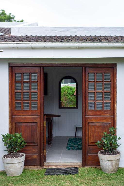 an entrance to a house with a wooden door at Disselblom Cottage in Sedgefield