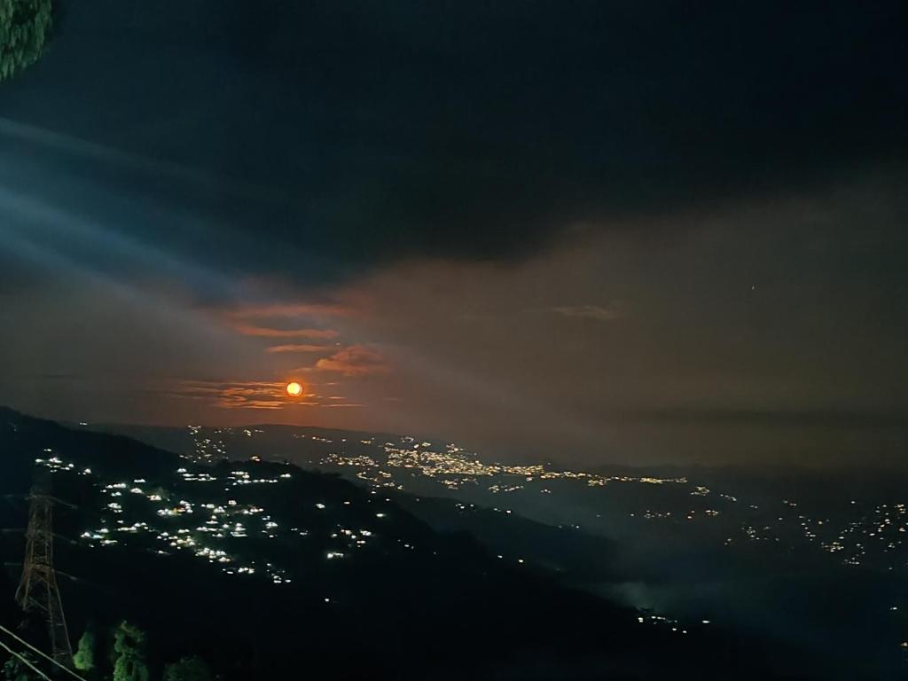 a view of the sun setting over a city at Dobhanay Homestay in Simāna Basti