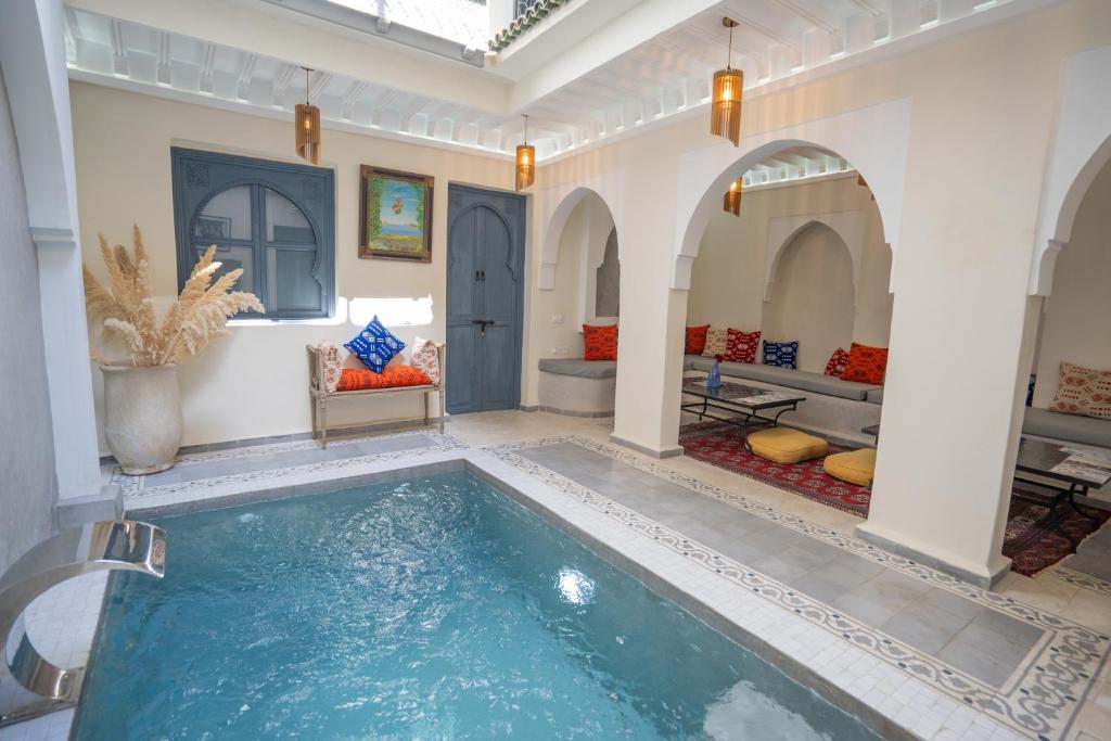 a large indoor pool in a room with a large room with at Riad Blue Berry & SPA in Marrakesh